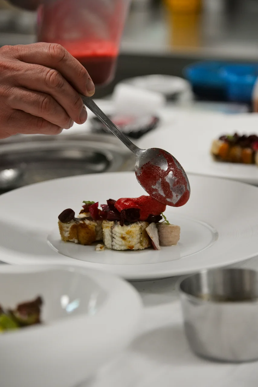Chef meticulously preparing a signature dish at Pearl Frostichard